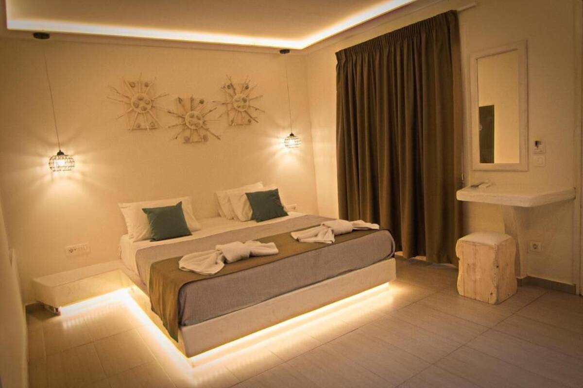 A modern bedroom with a large bed, bedside lamps, a vanity, and a mirror.