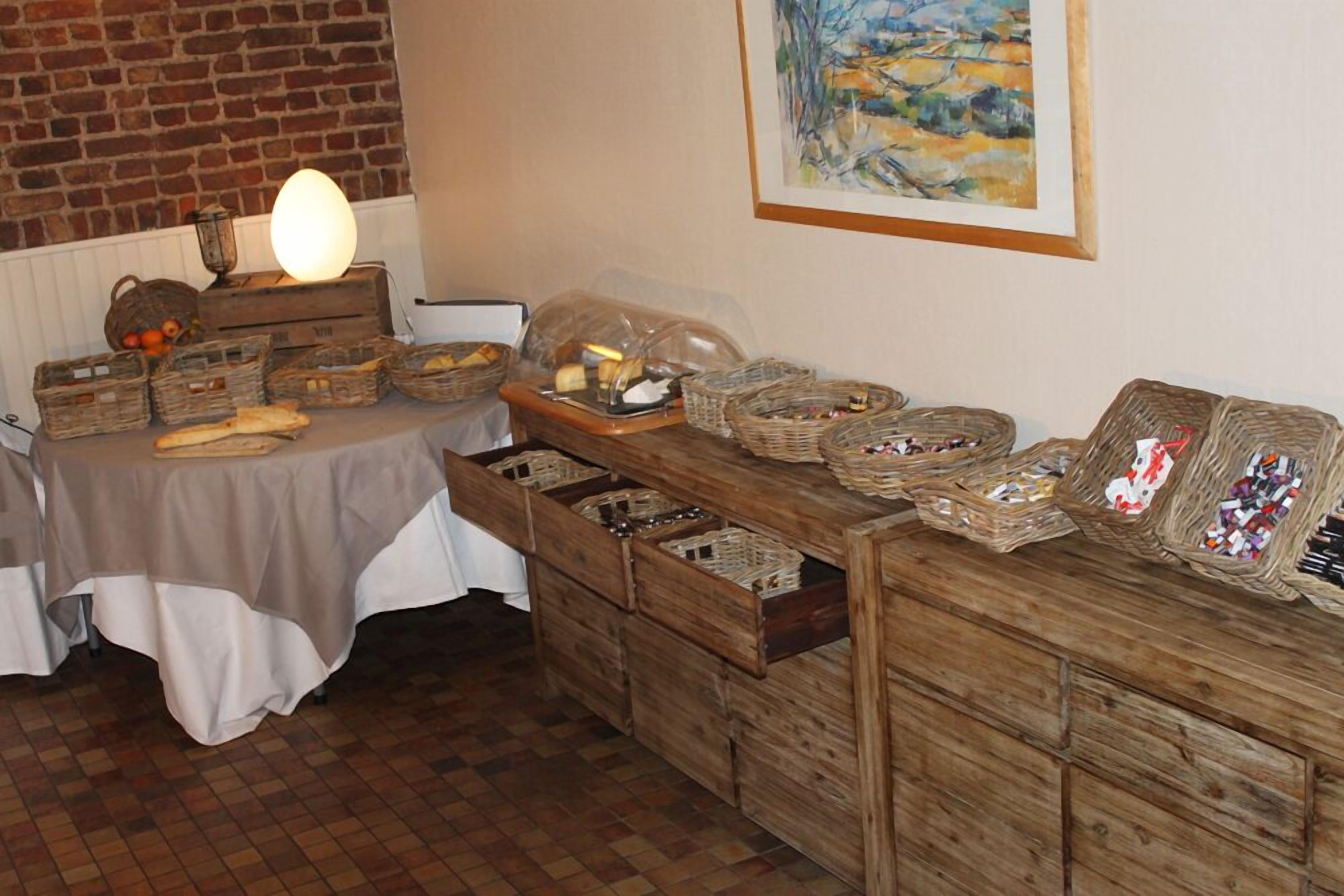 A buffet setup with wicker baskets and wooden drawers filled with food items.