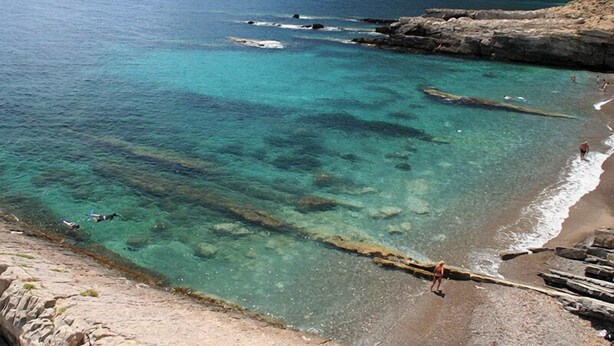 A coastal landscape with clear turquoise waters, rocky cliffs, and a sandy beach. - Marettimo Residence (Marettimo)