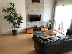 Family Apartment, 1 Bedroom, Balcony | Living room | 50-inch flat-screen TV with digital channels, TV