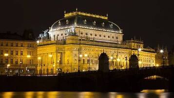 A historic building with a prominent dome and classical architecture, located by a river.