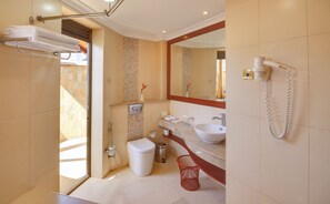 A modern bathroom with a shower, toilet, sink, and a hairdryer on the wall. - Enashipai Resort & Spa (Naivasha)