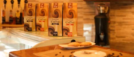 A display of Enashipay Coffee boxes in a café setting.