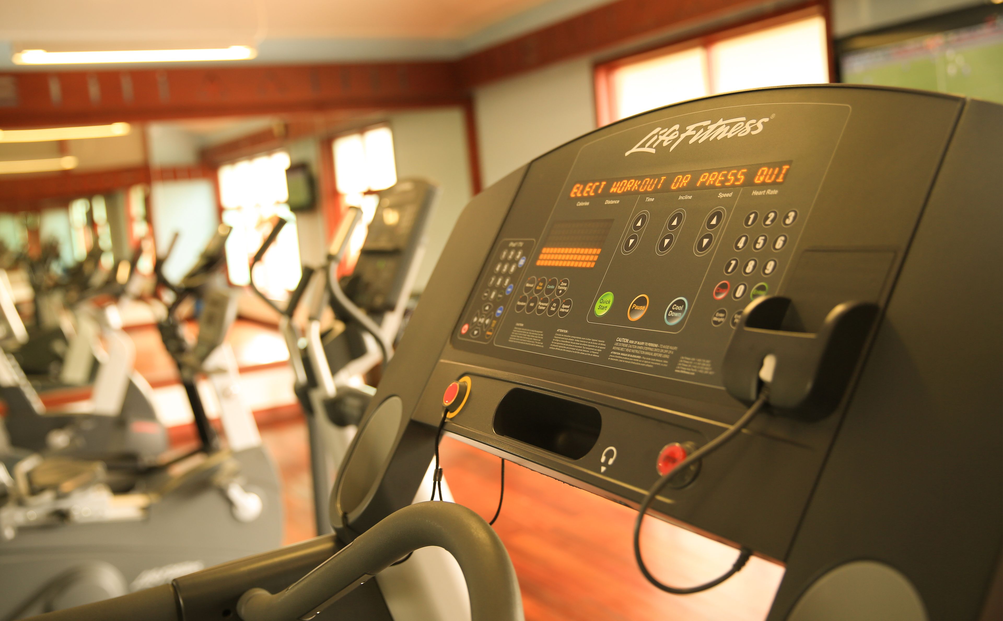 A gym equipment control panel with various buttons and settings.