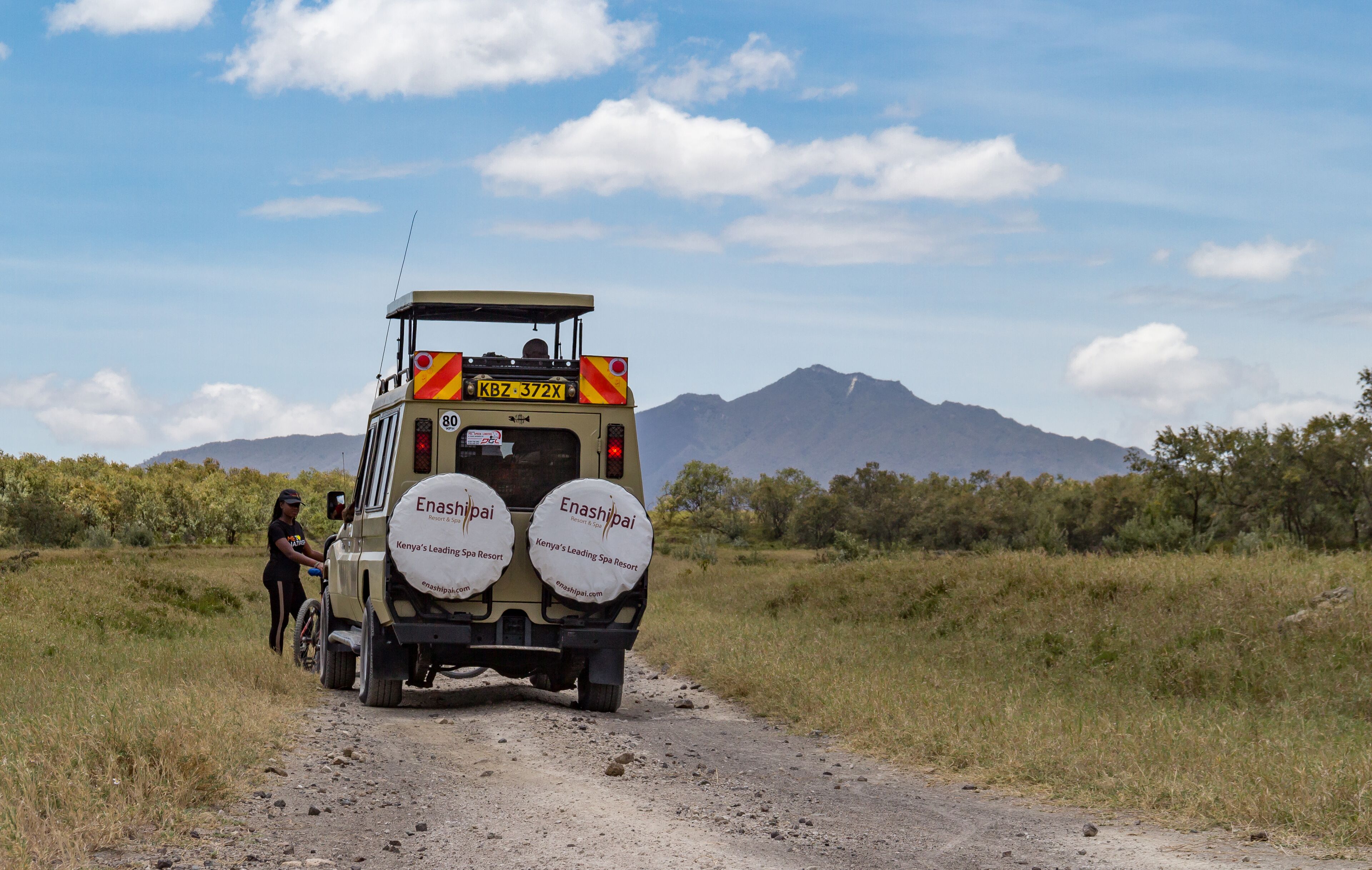A safari vehicle with "Kenya's Leading Spa Resort" branding on its back.