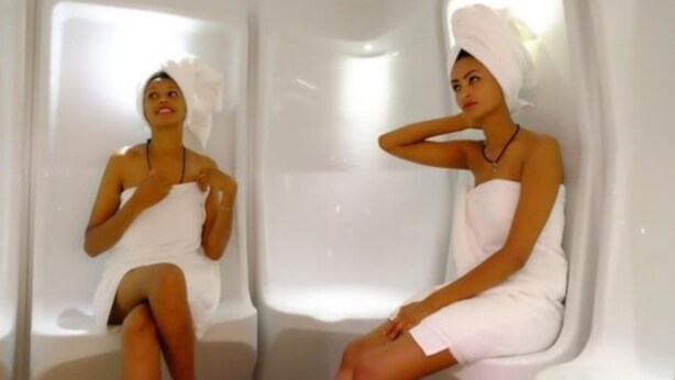 A person sitting in a bathtub with a towel wrapped around their body. - Abyssinia Renaissance Hotel (Addis Ababa)