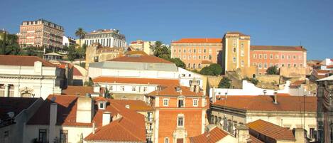 A densely packed urban area with historic buildings, some with red-tiled roofs and others with white facades.