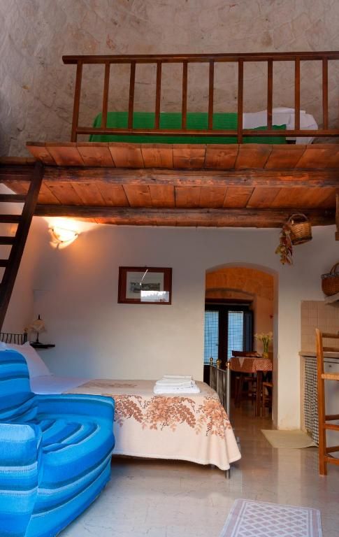 A bedroom with a bunk bed, a desk, and a chair.
