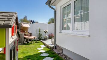 Enjoy a peaceful retreat in this serene backyard oasis with a seating area and lush greenery.