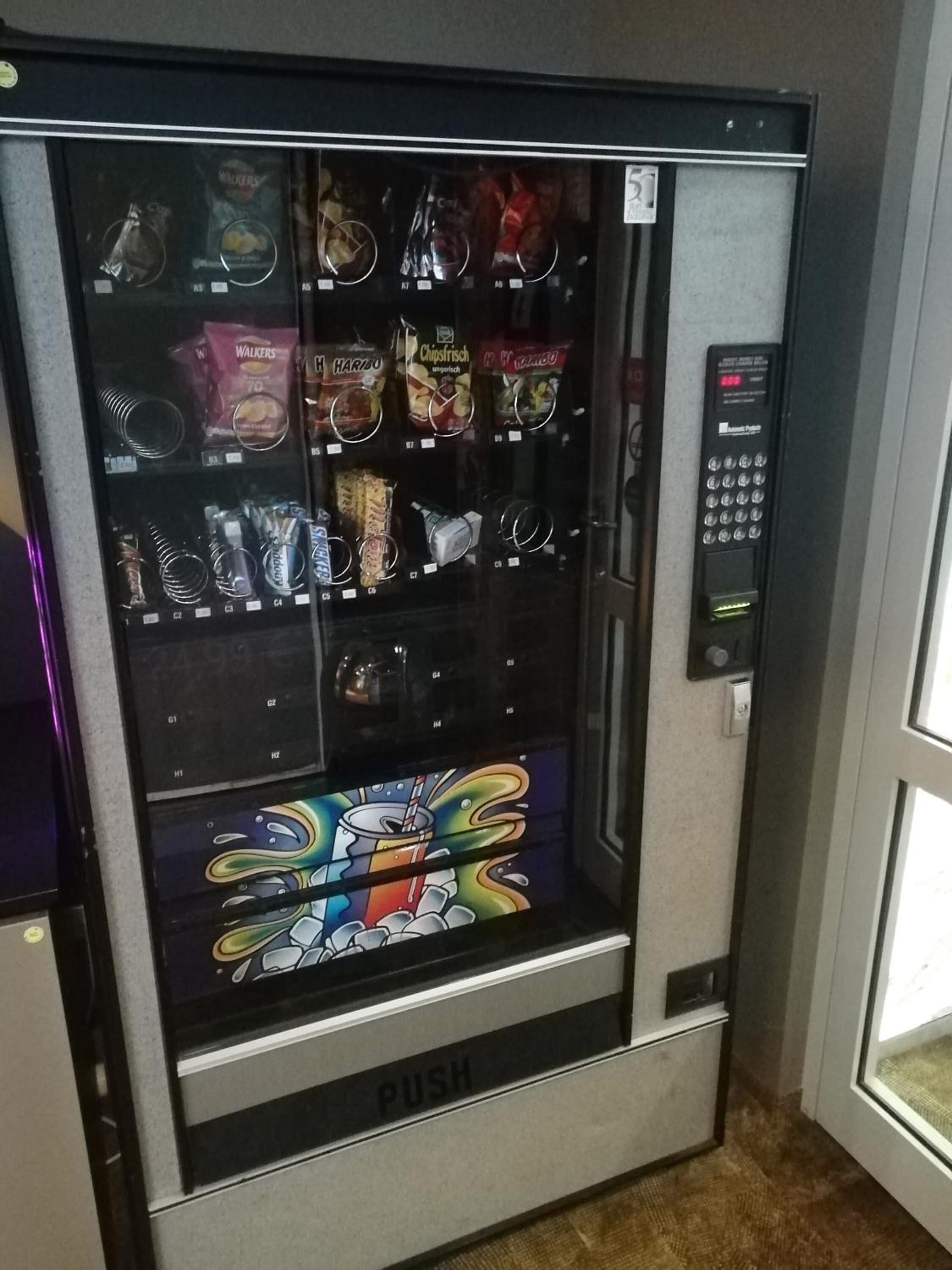 A vending machine with various snack options.