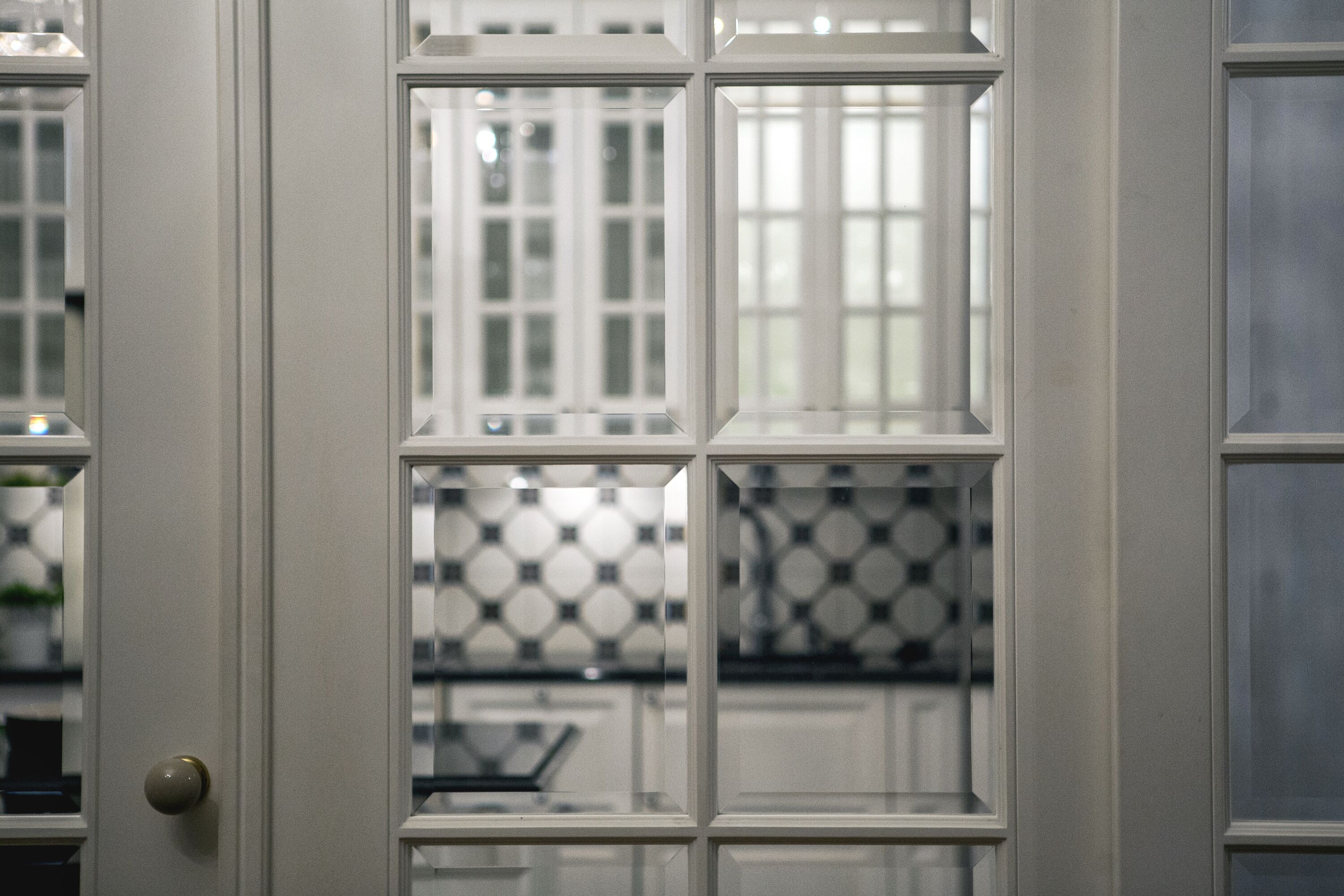 A white door with a glass panel and a round doorknob.