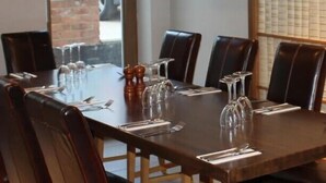 A conference room with a long table, leather chairs, and clear glassware. - George Hotel (Bishop's Stortford)