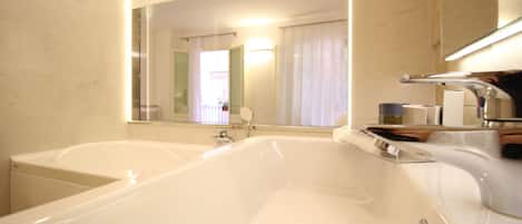 A modern bathroom with a large bathtub and a separate shower area.