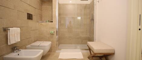 A bathroom with a bathtub, a shower, and a toilet.