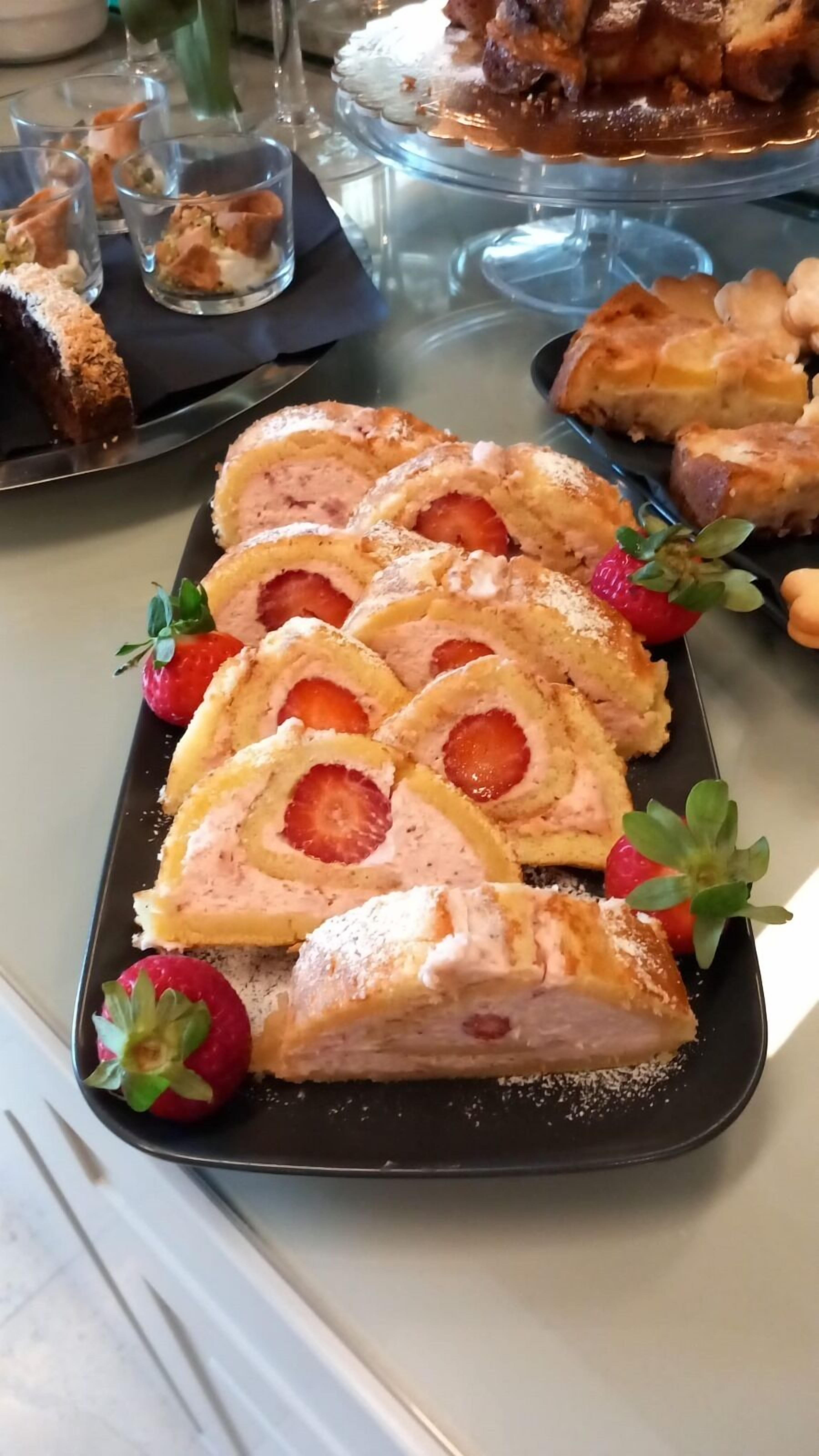 A dessert platter with sliced pastries and strawberries.