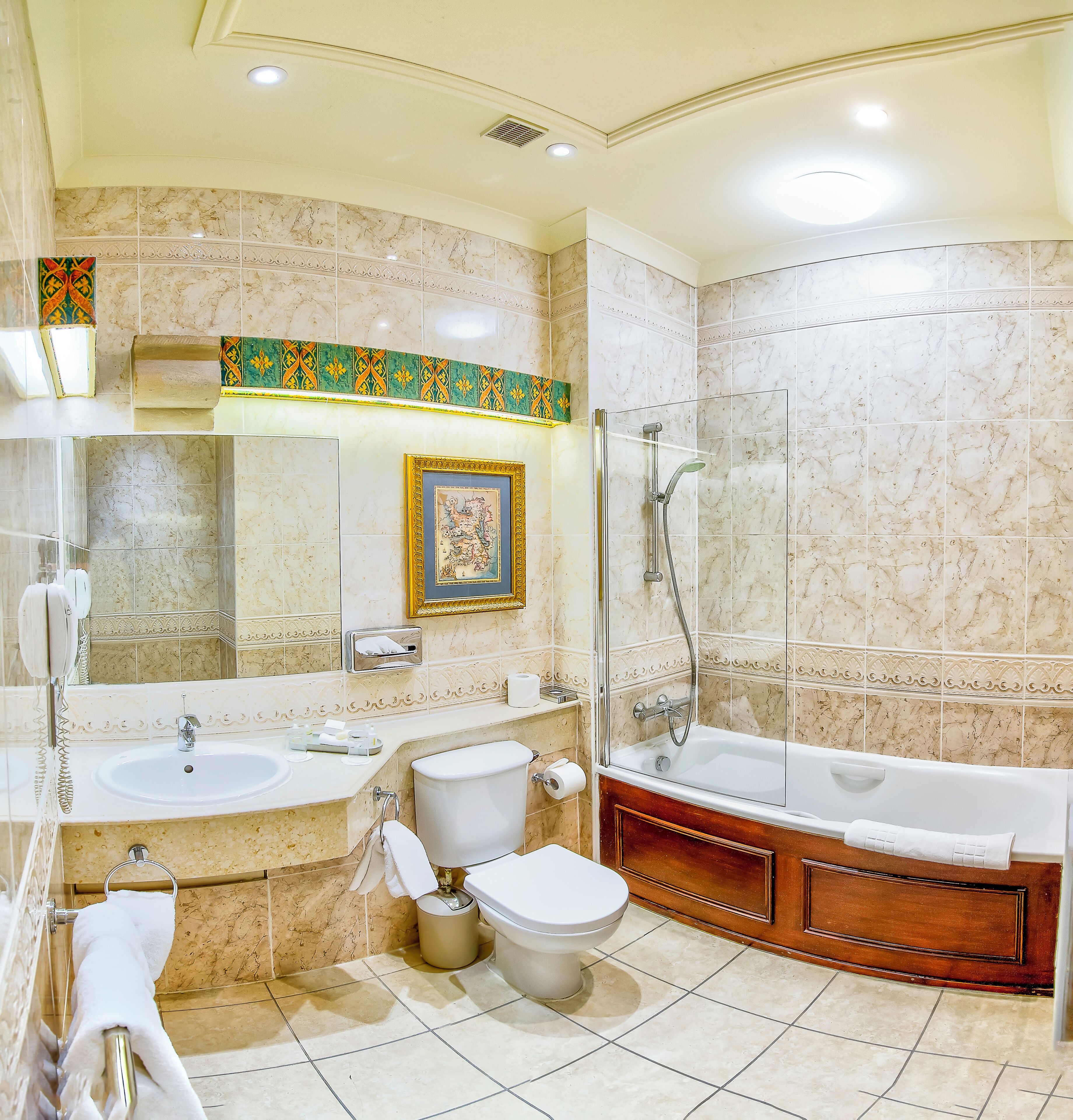 A bathroom with two sinks, a toilet, a bathtub, and a shower.