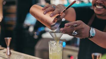 A person pouring a drink into a glass.