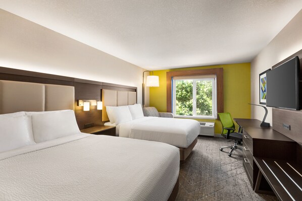A hotel room with two beds, a desk, a chair, a TV, and a window with a view of greenery. - Holiday Inn Express & Suites Redding by IHG (Redding)