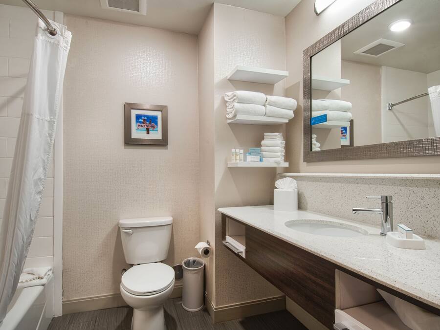 A modern bathroom with a toilet, sink, and shower area.