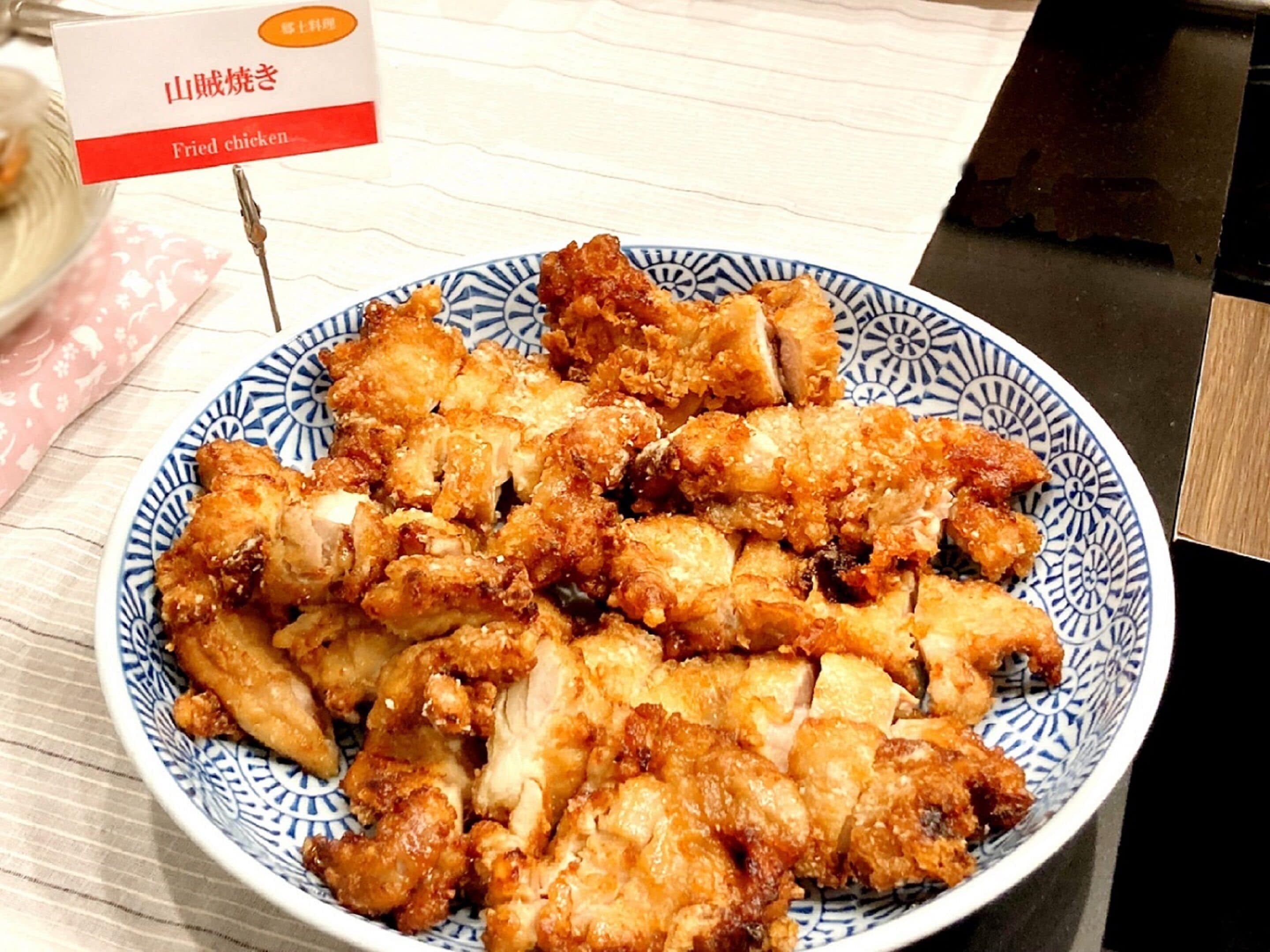 A plate of fried chicken on a blue and white patterned plate.