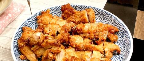 A plate of fried chicken on a blue and white patterned plate.
