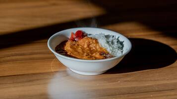 A bowl of food on a wooden table.
