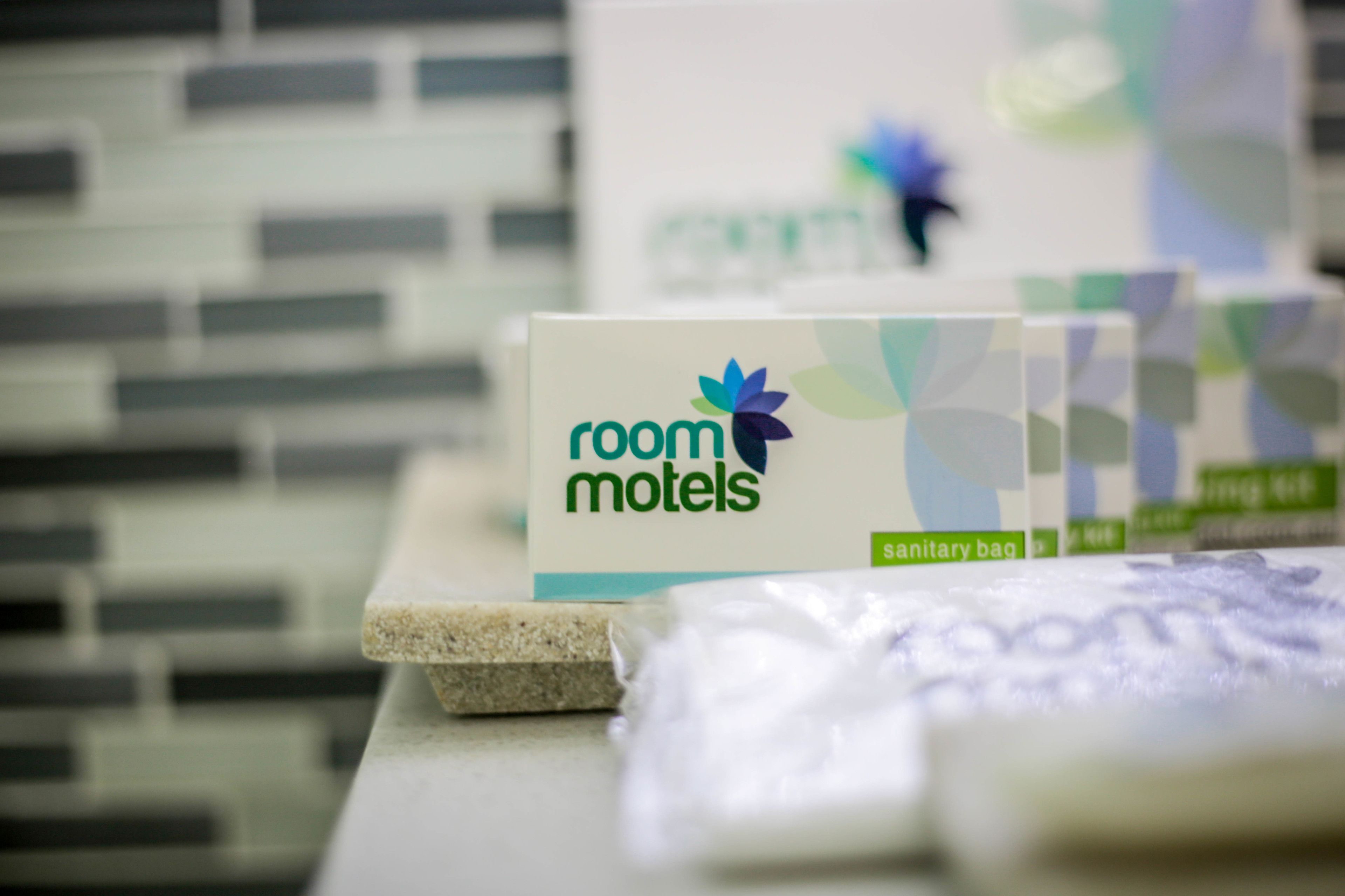 A display of room motel signs with a focus on the 'room motels' branding and a sanitary bag.