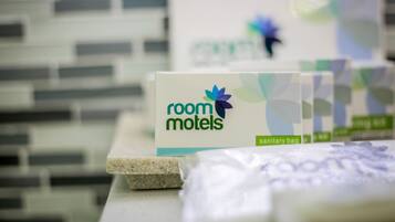 A display of room motel signs with a focus on the 'room motels' branding and a sanitary bag.