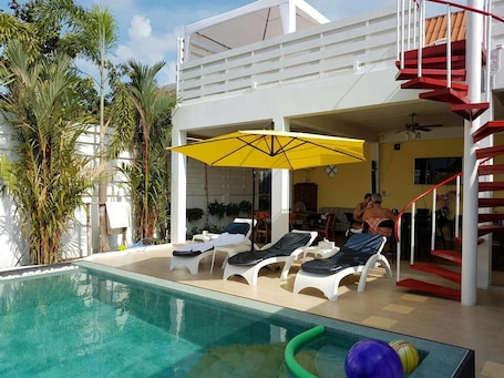 Outdoor pool, pool loungers. Barefeet Naturist Resort