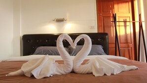A bed with a heart-shaped towel arrangement. - Barefeet Naturist Resort (Bangkok)