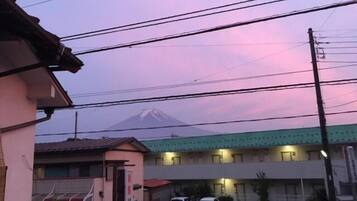 Edificio con zona de estacionamiento y vista a la montaña.