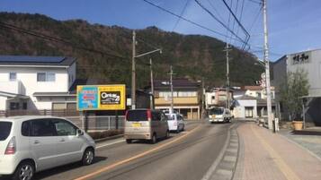 Una carretera con coches, edificios y un cartel.