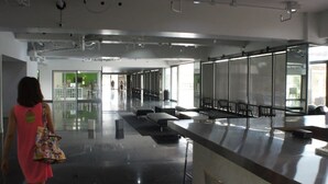 A spacious, modern lobby with a long reception desk, seating area, and large windows allowing natural light. - Pia Marine Condominium (Tamuning)