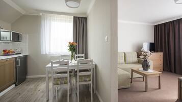 Deluxe Double Room, 1 King Bed, Kitchenette | Living area | Flat-screen TV