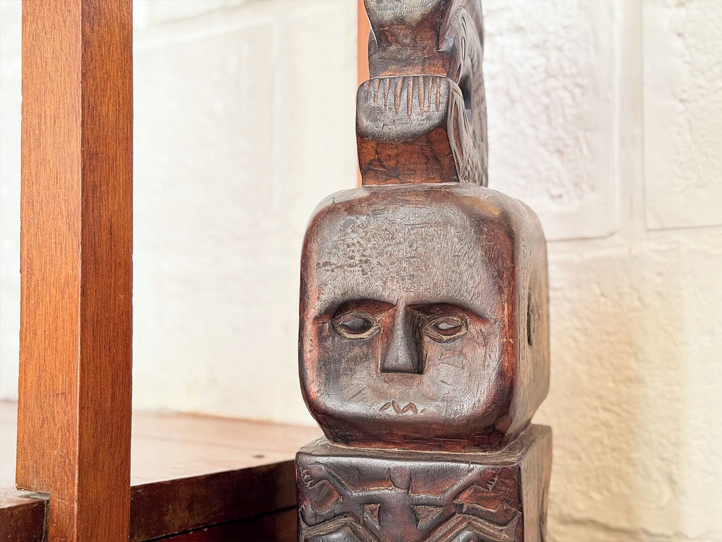 A wooden structure with carved details, possibly a part of a larger piece.