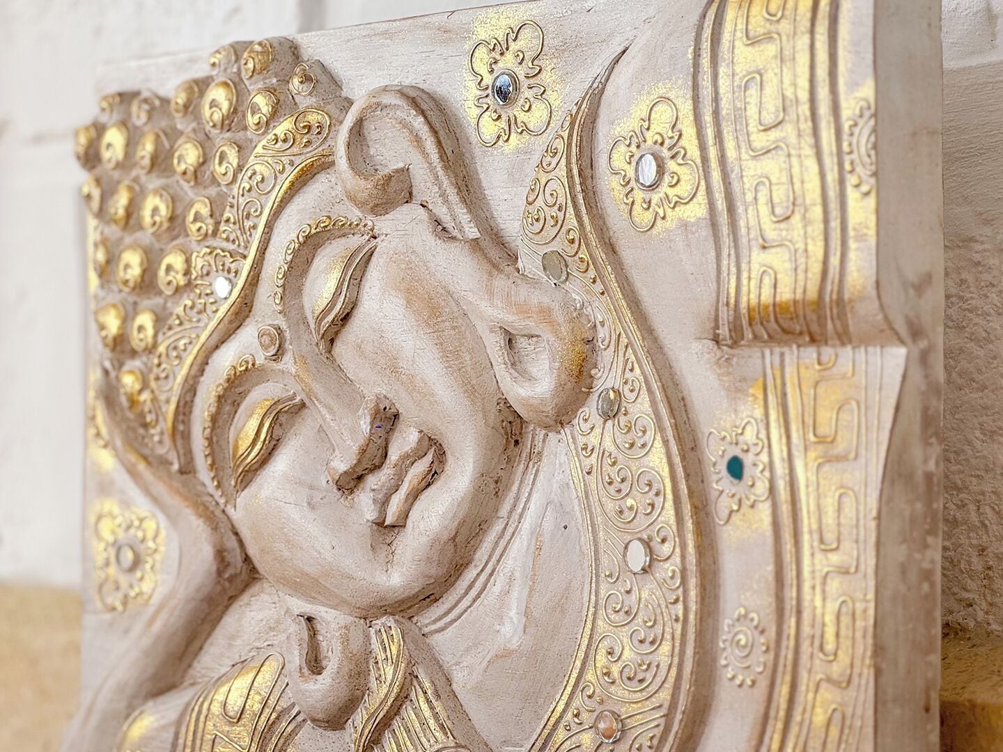 A detailed architectural carving with ornate patterns and a central figure.