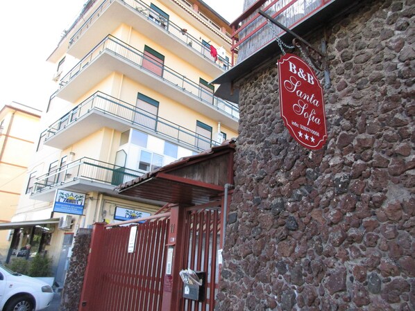 A stone building with a red sign for B&B La Seta.