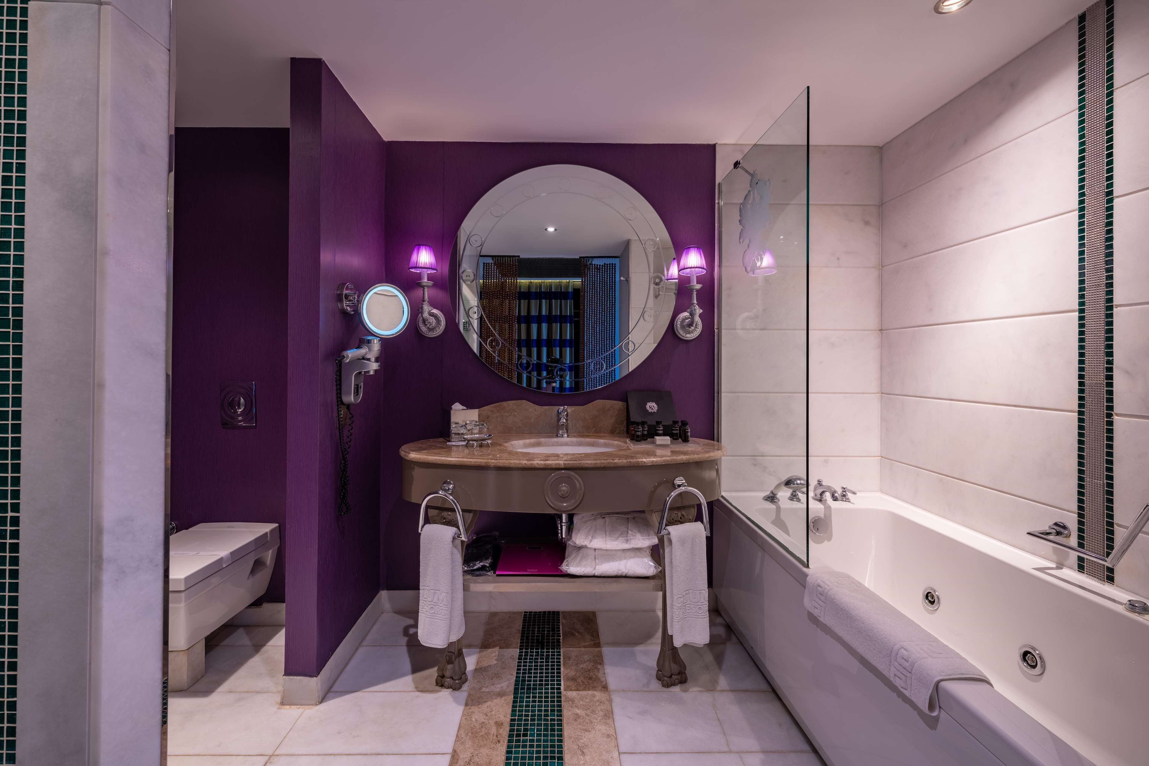 A modern bathroom with a vanity, sink, and bathtub.