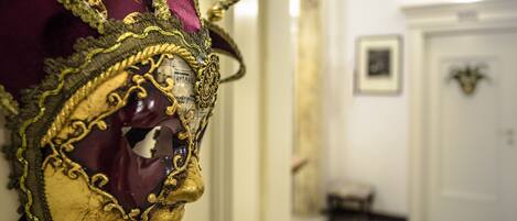 A close-up of an ornate mask with gold and purple details.