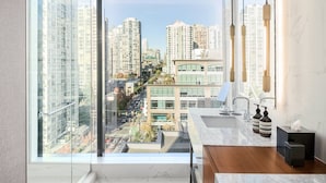 A modern kitchen with a large window overlooking a cityscape. - the DOUGLAS, Autograph Collection (Vancouver)