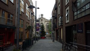 A narrow street with brick buildings, a pub named 'Queen of Tarts', and a sign for 'Old City Temple Bar'. - MetroStays - Temple Bar 5 (Dublin)