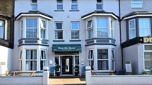 A two-story building with a sign for the Denville Hotel. - Denville Hotel (Blackpool)