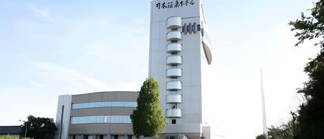 A multi-story building with a prominent sign at the top.