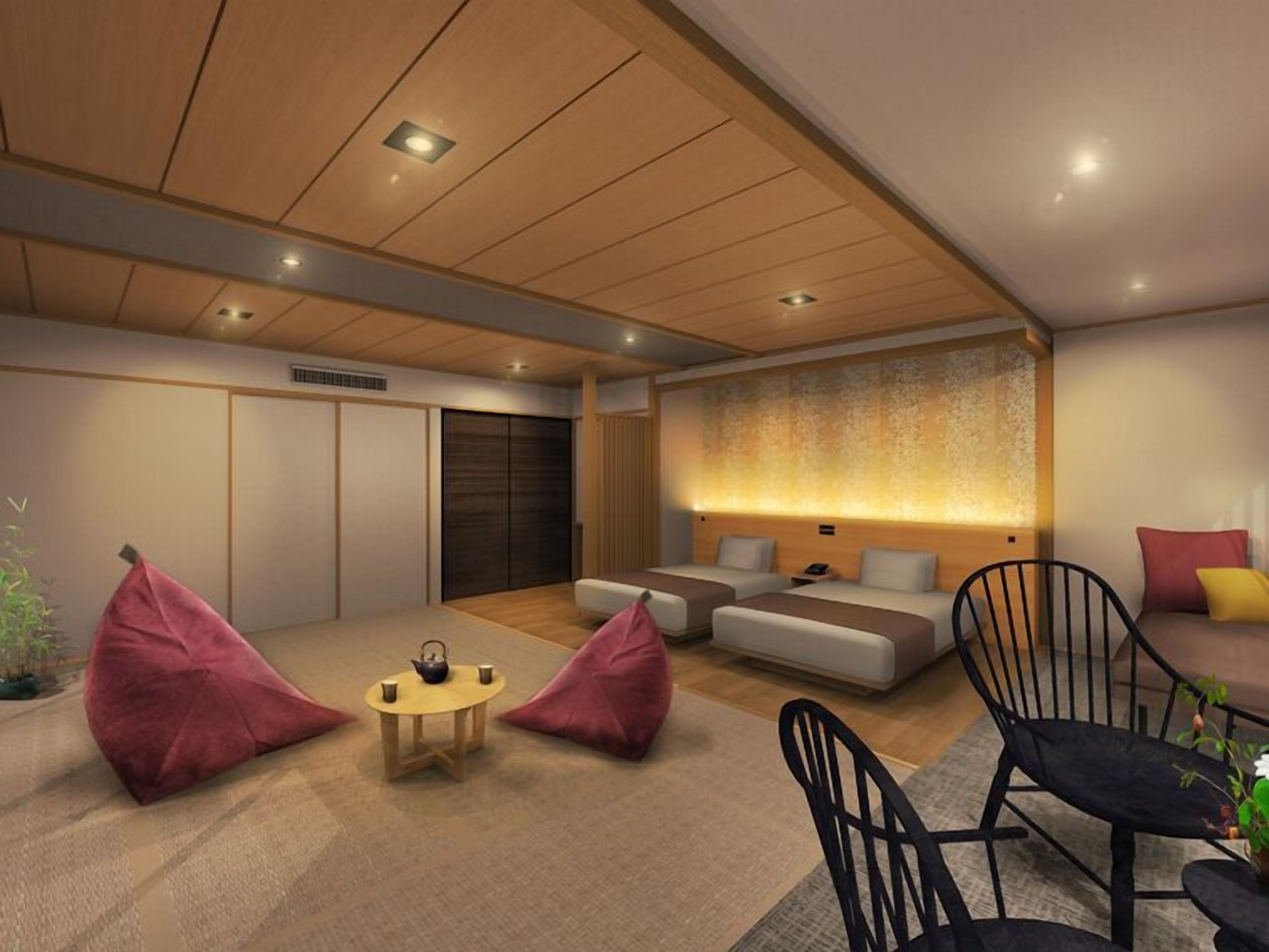A modern hotel room with a sofa set, a small round table with a teapot, and two bean bags.
