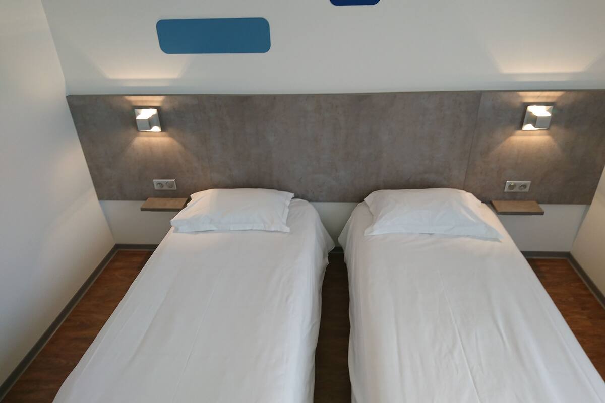 twin room | premium bedding, desk, blackout curtains, soundproofing