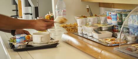 A breakfast buffet with various food items and beverages.