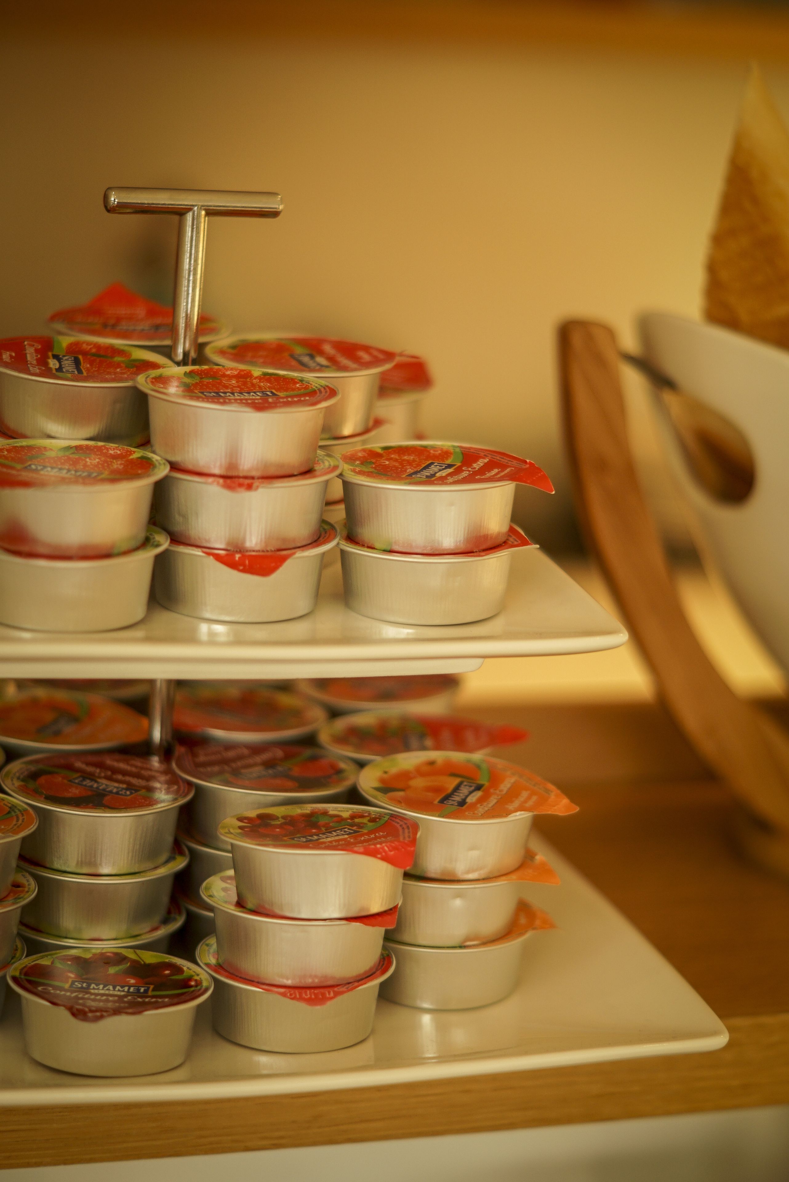 A tiered display of canned goods on a white plate.