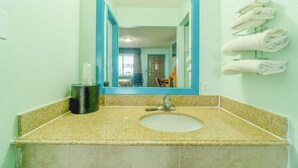 A bathroom with a sink, mirror, and towels on a rack. - Budget Inn By OYO Edinburg Hwy 281 (Edinburg)