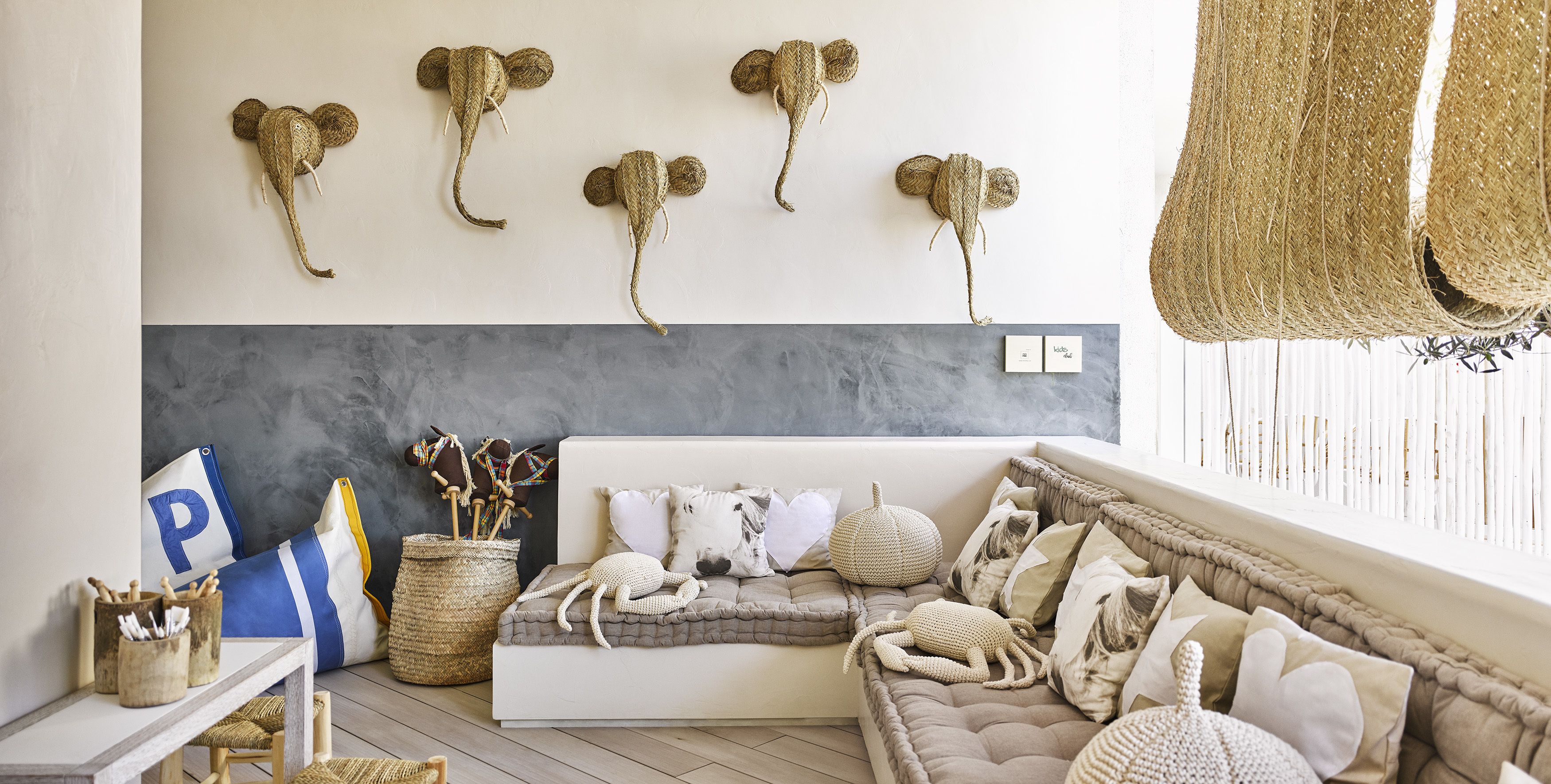 A cozy living room with a sofa, decorative wall art, and a window with natural light.