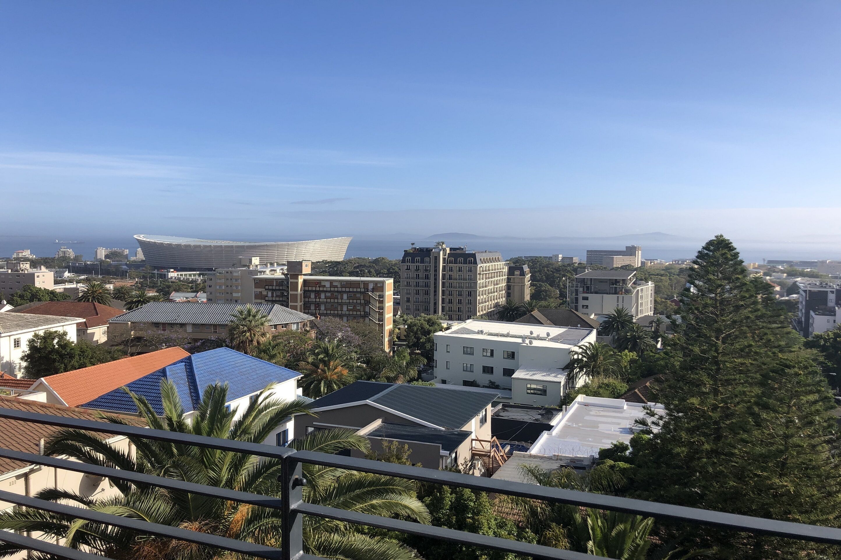 A cityscape with various buildings, including a distinctive stadium and residential structures.